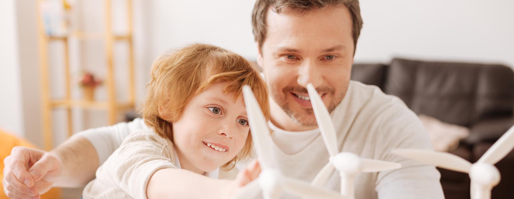 Image of father with son in front of wind turbine model